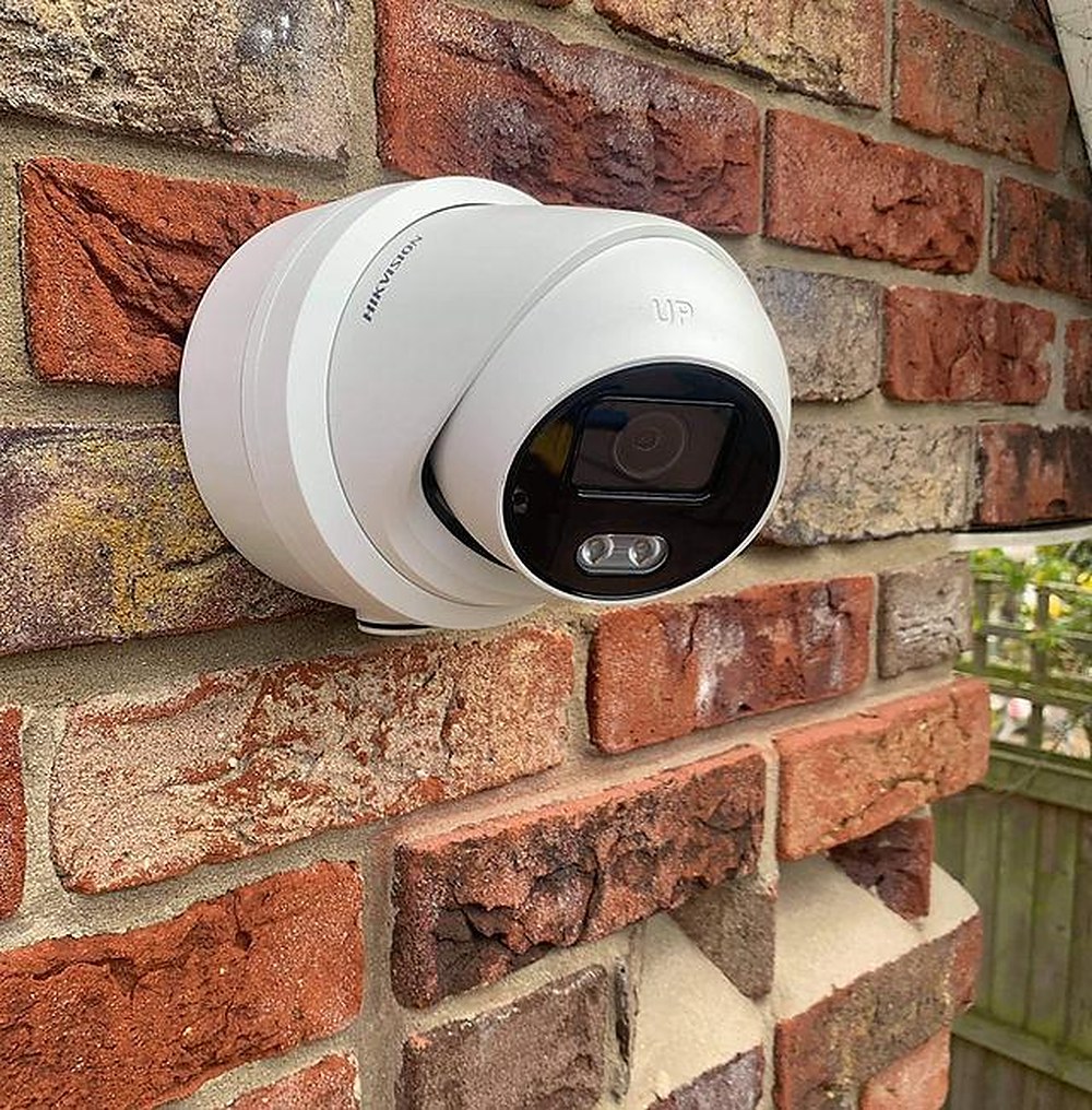 Hikvision CCTV camera fitted to a brick wall in Hackney